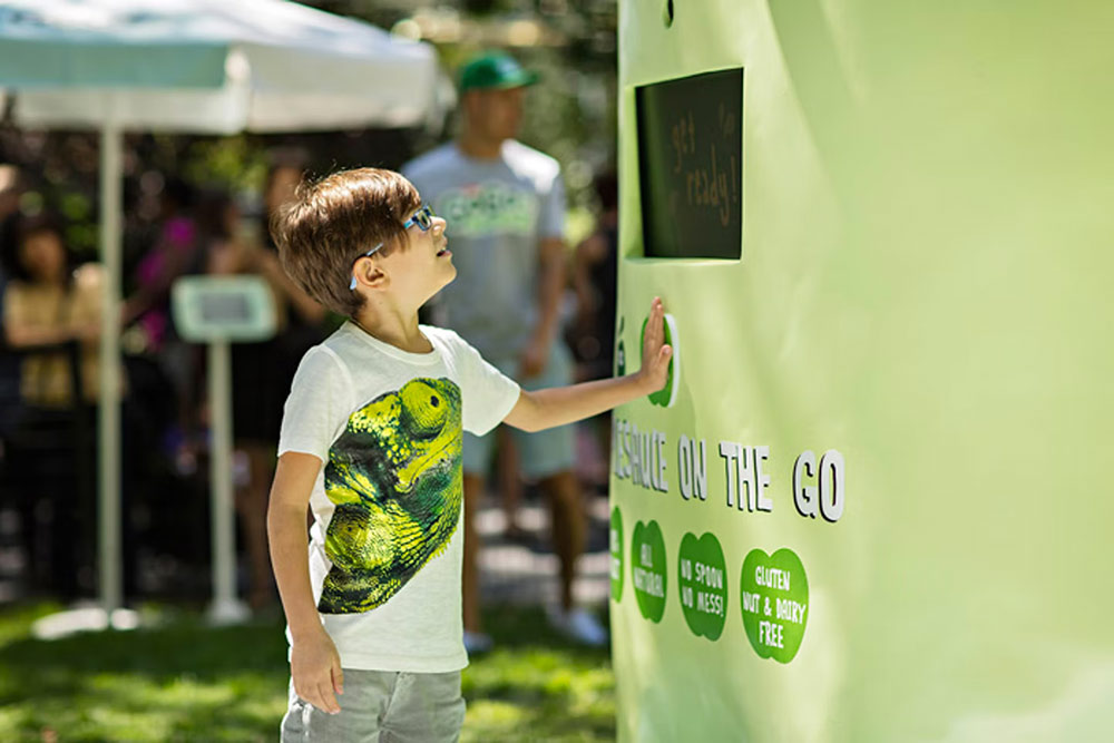 Square Design MKG Goodness Machine GoGo Squeez Flying Applesauce interactive vending machine